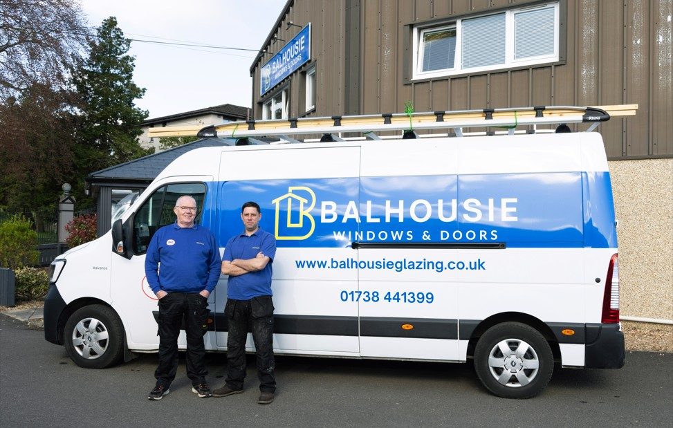 Two Balhousie Glazing fitters standing in front of a branded company van outside the Perth premises
