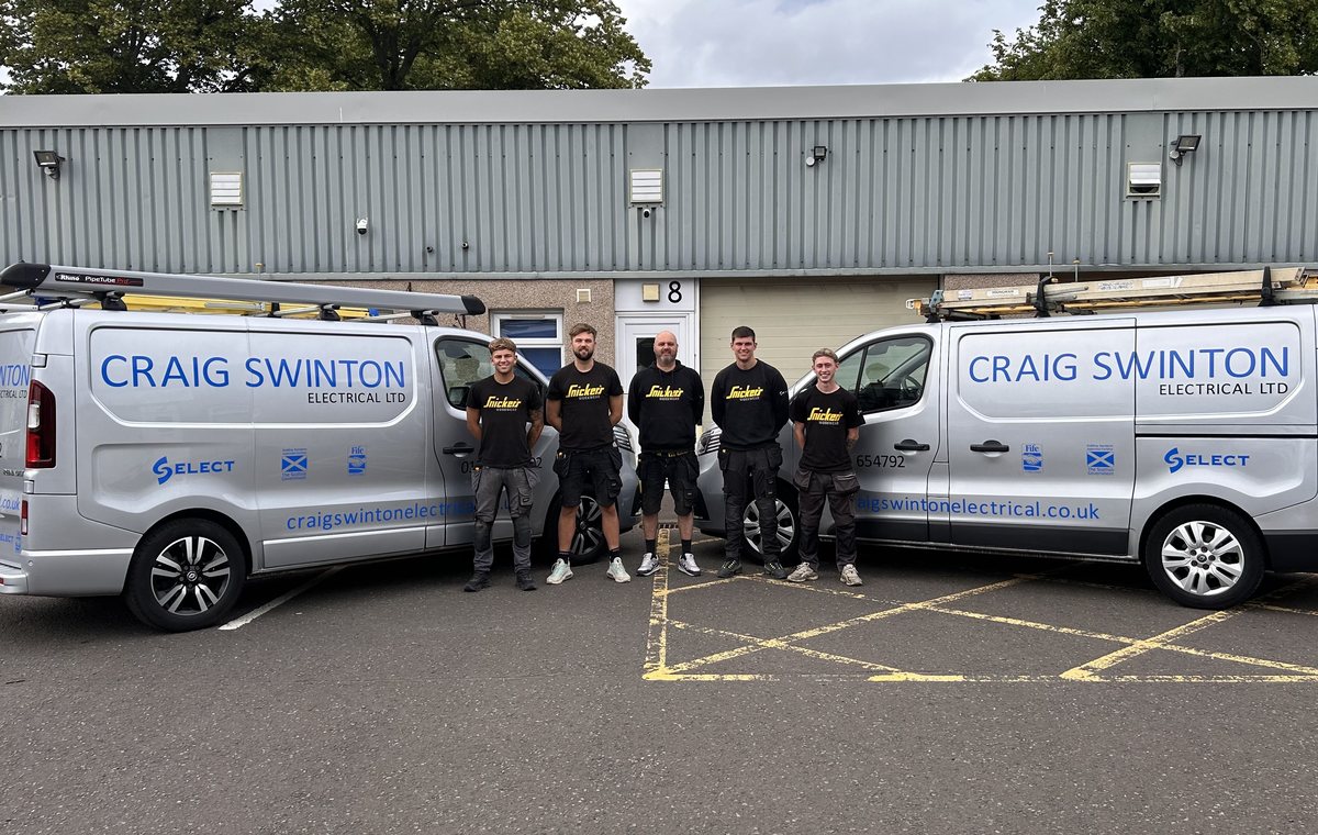 The Craig Swinton Electrical team between two branded vans outside the Cupar unit, Trading Standards vetted Fife Trusted Trader