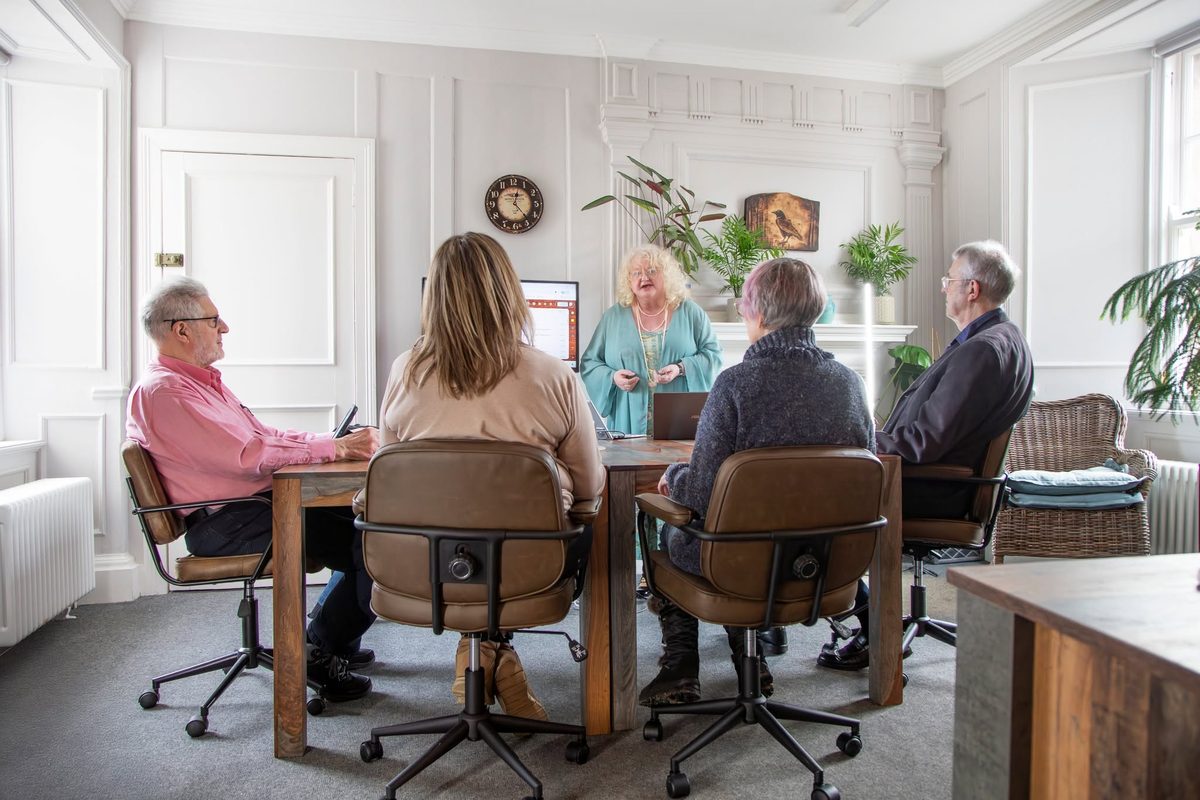 Alison Low leading a small group workshop for four adult learners around a table at Eildon IT Training in Haddington House